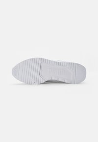 White sneaker sole with textured rubber surface, ridges for grip, and embossed logo. Features a rounded toe and flat heel.