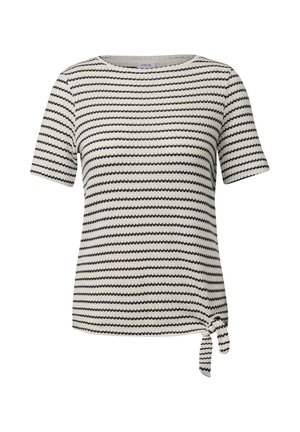 Lyhythihainen, pyöreäkauluksinen t-paita vaaleassa sävyssä, jossa on mustia sahalaitaisia raitoja. Hihoissa on solmittu yksityiskohta helman kohdalla. Valmistettu tekstuurista kankaasta.