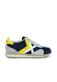 Zapatillas deportivas en azul marino y gris con acentos blancos, detalles amarillos y un acabado de ante texturizado. Presentan cordones y una suela con patrón.