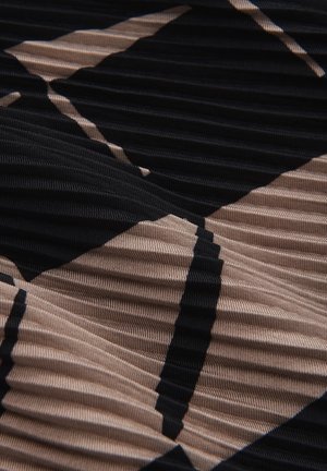 Textured fabric in black and beige, featuring a geometric pattern with pleated details, creating a visual layer effect.