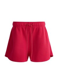 Shorts de sport rouges avec taille élastique et cordon, fabriqués en tissu léger, conçus pour le confort et la mobilité.