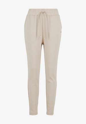 Pantalons de jogging beiges avec taille élastique et cordon de serrage, présentant une texture lisse et un design de jambe fuselée. Détails de marque minimalistes.