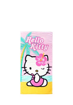 Hello Kitty with pink flower on head sits on yellow sand at beach with palm tree and sea, "Hello Kitty" text in pink above.