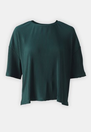 Teal, short-sleeved top made of ribbed fabric. Features a round neckline and a loose fit, with side slits near the hem.