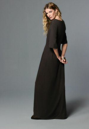 Maxi dress in dark brown fabric with a relaxed fit, wide sleeves, and side slits, featuring simple design and smooth texture.