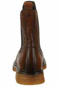 Botas de cuero marrón hasta el tobillo con paneles elásticos en los lados, puntera redondeada, suela de goma texturizada y detalle de la marca en el talón.