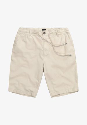 Beige shorts lavet af blødt stof med elastisk talje og snøre. Har to sidelommer og en afslappet pasform ved knæ længde.