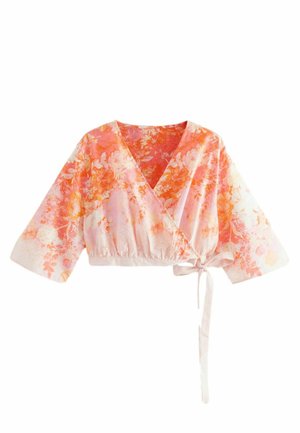Top a fantasia floreale in tonalità di rosa e arancione, con scollatura a V profonda, maniche ampie, orlo elasticizzato e dettaglio in vita con lacci.