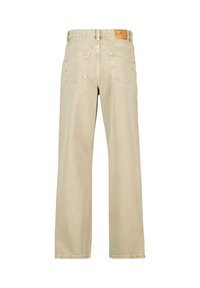 Beige levelet farkut, joissa on hieman haalistunut pinta, kaksi takataskua ja merkkilogo oleva nahkapaikka vyötäröllä.