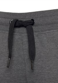 Graue Sweatpants mit einem schwarzen Kordelzug, strukturiertem Taillenbund und flachem Design mit Metallenden für eine einfache Anpassung.