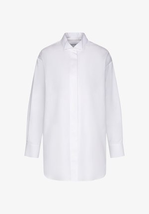 Hvid oversized skjorte med lange ærmer, skjult knapstolpe og spids krave, vist mod en ensfarvet baggrund.
