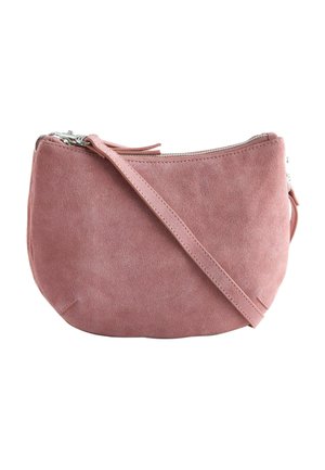 Small dusty pink suede crossbody bag with silver zipper and slim strap, set against a white background.
