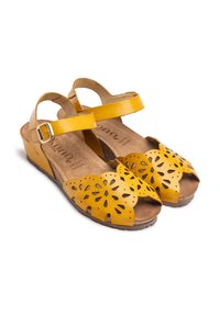 Yellow leather sandals with a perforated butterfly design, open-toe, a padded footbed, and an adjustable ankle strap with a silver buckle.