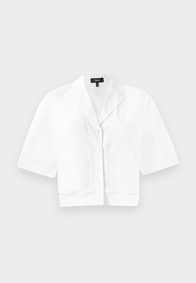 White cropped short-sleeve button-up shirt with a pointed collar, featuring a subtle textured stitch along the hem and a smooth fabric finish.