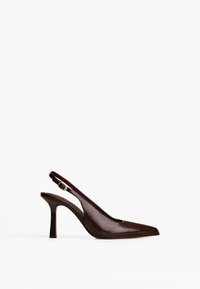 Brown leather slingback high heel with a pointed toe and smooth texture, featuring a cut-out design and an adjustable strap at the heel.