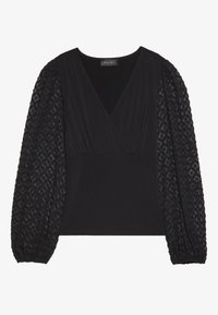 Haut noir avec un décolleté en V, un corps ajusté et des manches bouffantes texturées avec un motif en diamant. Fabriqué en matériau doux et extensible.