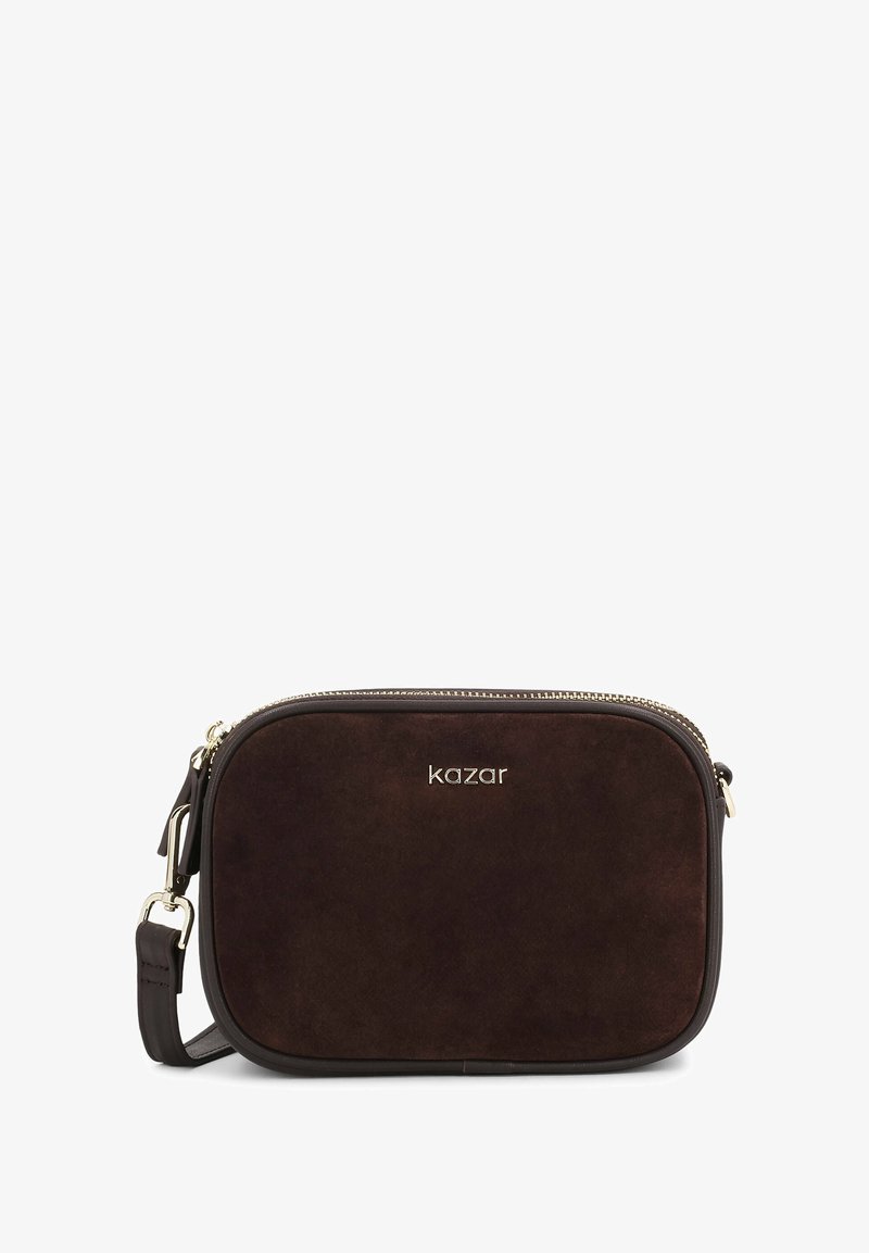 Pruun nahast õlakott, millel on tõmblukk, kuldne riistvara ja eemaldatav rihm. Omab ümarat ristkülikukujulist disaini.