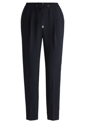 Pantaloni blu navy con un design affusolato, vita elastica e chiusura con cordino. Realizzati in tessuto morbido con tasche laterali.