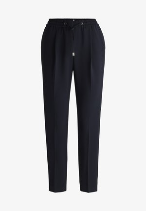 Marineblauwe broek met een taps toelopend ontwerp, elastische tailleband en trekkoordsluiting. Gemaakt van een gladde stof met zijzakken.