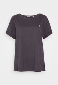 T-shirt en coton gris foncé avec une coupe ample, des manches courtes retroussées, et une petite broderie de palmier sur la poitrine gauche. Encolure arrondie.