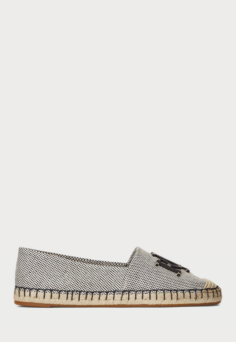 Svart och vit mönstrad espadrille med en jute-sula, med rund tå och dekorativ rosett på ovandelen.