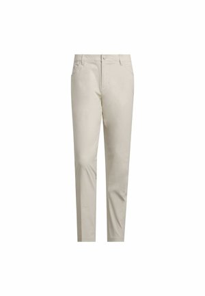 Beżowe spodnie wykonane z gładkiej tkaniny, o zwężanym kroju, z przednimi kieszeniami i zapięciem na guzik w pasie. Czysty design, bez wzorów.