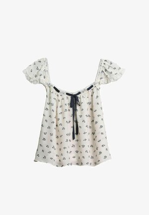 Biała bluzka odkrywająca ramiona z małym czarnym kwiatowym nadrukiem, koronkowym wykończeniem na rękawach i czarną wstążką wiązaną przy dekolcie.