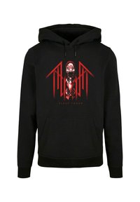 Mustapaita, jossa on keskipisteenä punainen grafiikka, joka sisältää kasvokuvan ja abstrakteja elementtejä. Paidassa on etutasku ja säädettävä huppu.