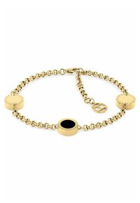 Pulsera de cadena de oro con eslabones circulares, dos discos de oro, uno con un centro negro, y un charm circular con un diseño geométrico.
