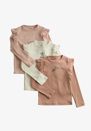 Tres camisetas de manga larga para niños en tonos beige, crema y marrón claro, con detalles de volantes en los hombros y estampados y textos con temática de Bambi.