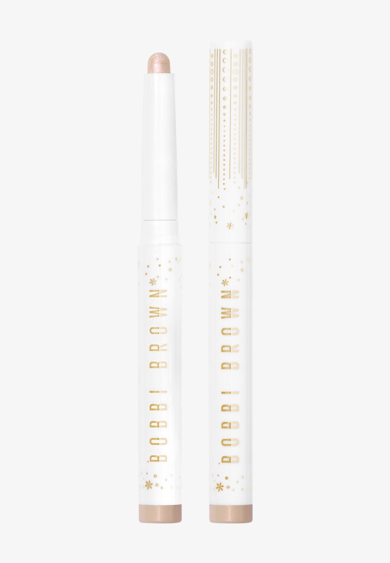 Bobbi Brown highlighter stick met een lichtroze punt en een witte buis met gouden accenten en sterpatronen, cilindrische vorm, gladde textuur.