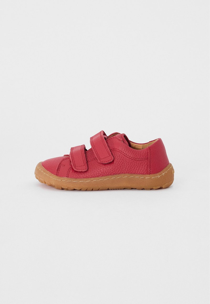 Red leather shoe with two Velcro straps, rounded toe, and a textured surface. Gum rubber sole provides flexibility and traction.