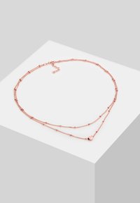 Rosaguld lagd necklace med fine kædelinks, runde perler og en lille hjertevedhæng. Justerbar længde med en clasp lukning.