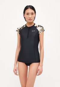 Black short-sleeve surf top with floral pattern at shoulders, half zip, soft fabric, form-fitting design, logo on the front.