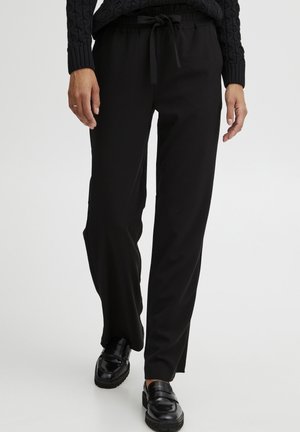 Schwarze, hochtaillierte Hose mit lockerer Passform, ausgestattet mit einem elastischen Bund und Kordelzug. Glatte Textur, verjüngt sich am Knöchel.