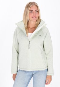 Svetlo zelena zip-up jakna z flisasto teksturo, visokim ovratnikom in stranskimi žepi. Ima gladko notranjo podlogo in detajl logotipa na prsih.