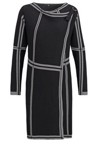 Robe noire à manches longues avec motifs de lignes géométriques grises, encolure asymétrique et détail bouton sur l'épaule droite.