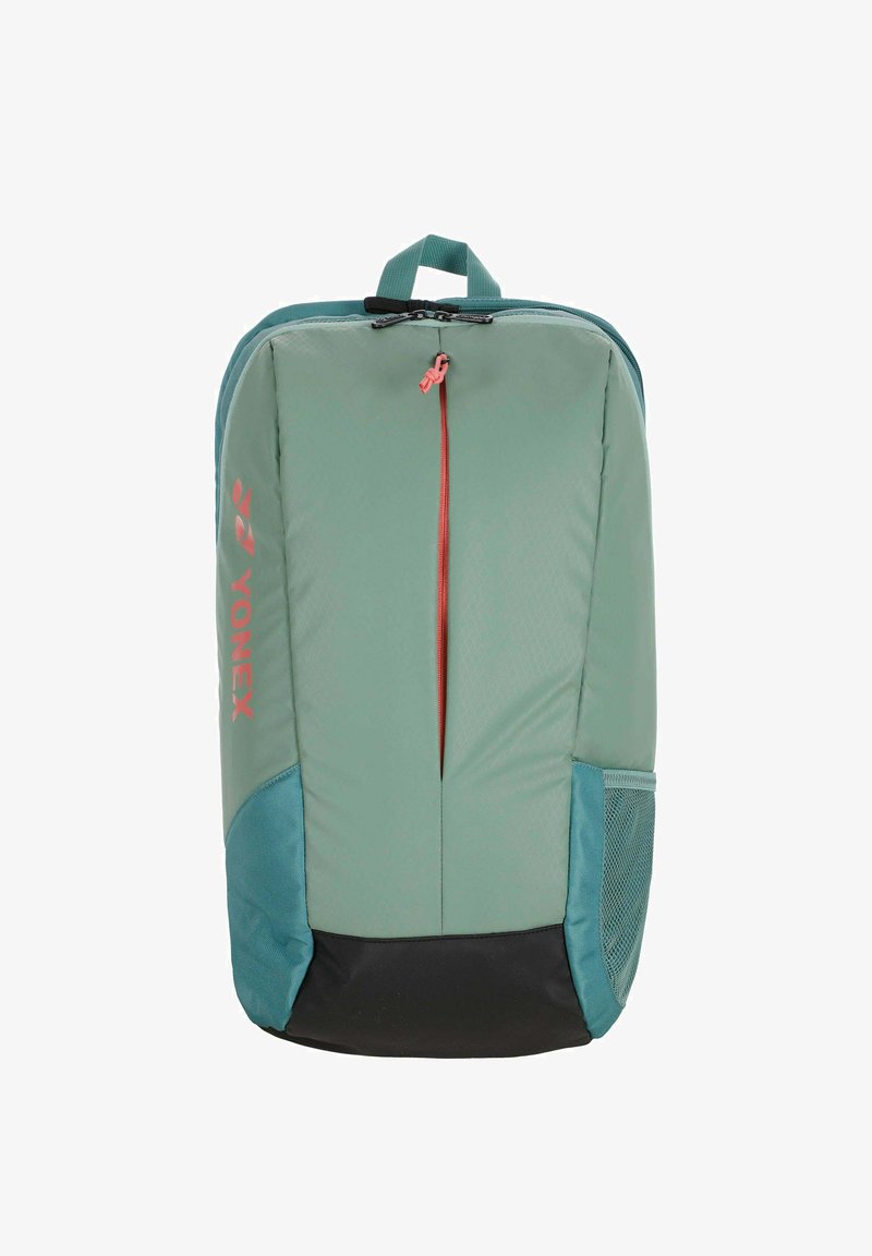 Sac à dos de sport Yonex vert et bleu sarcelle avec fermeture éclair verticale à l'avant, poche latérale en filet et poignée de transport supérieure.