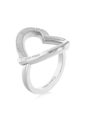Silver Calvin Klein ring featuring a partial ribbed heart shape and engraved brand name on smooth band.