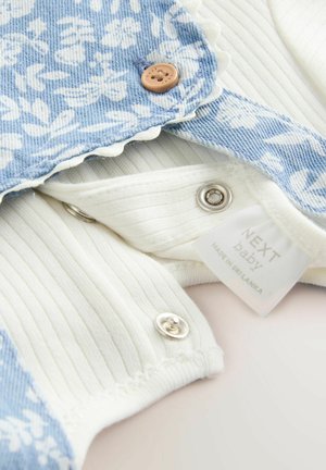 Denim bodysuit sinise lillemustriga, valgest ribakangast, lainelise servaga ja nööpidega kinnitustega. Includeerib sildi "NEXT baby".