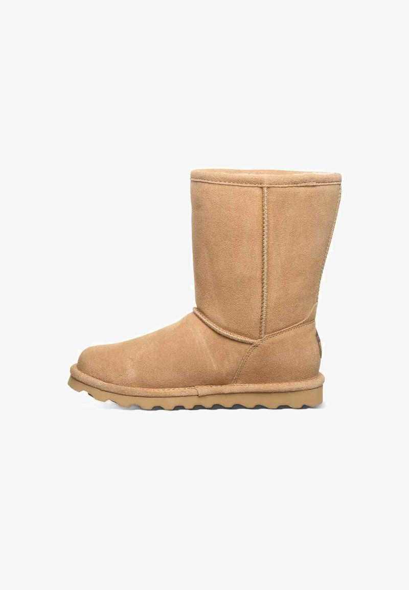 Tan suede ankle boot with a rounded toe, flat rubber sole, and stitched detailing. Simple design without embellishments or patterns.