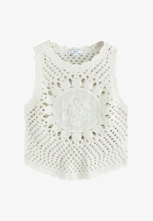 Biały bezrękawnik szydełkowy z wzorem rozbłysku słońca i centralnym okrągłym motywem, z kwiatowymi i otwartymi kratowymi wzorami.