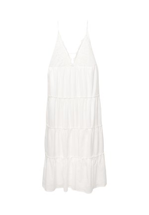 Witte gelaagde jurk met spaghettibandjes, kantdetails bij de halslijn en een losse, vloeiende silhouet gemaakt van lichtgewicht stof.
