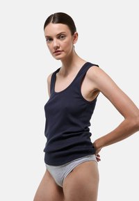 Débardeur bleu marine avec une texture côtelée et des larges bretelles, associé à des sous-vêtements gris clair. Design simple et ajusté.