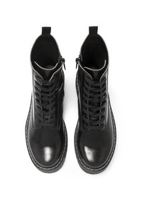 Botas de tobillo de cuero negro con un acabado suave, cordones en la parte frontal, cierre de cremallera y costuras blancas a lo largo de la suela. Presenta una punta redonda.