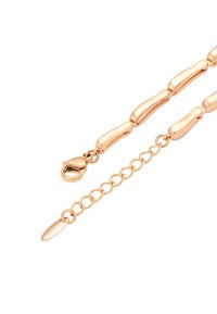 Náramek ve zlatém odstínu s eloxovanými, zaoblenými články a karabinkovým zapínáním. Obsahuje prodloužení řetězu s oválným přívěskem. Hladký, leštěný povrch.