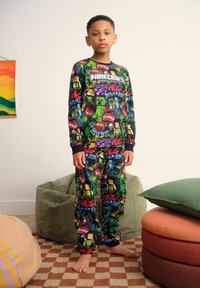 Minecraft-themed pajama set in black, featuring colorful graphics of characters and items. Comfy fit with ribbed cuffs and ankle.