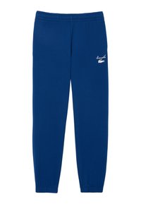 Blaue Jogginghose mit elastischem Bund, schmal zulaufenden Beinen und kleinem weißem Logo an der Oberschenkeloberfläche. Hergestellt aus weichem, dehnbarem Stoff.