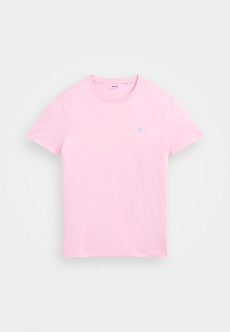 Roza bombažna majica s kratkimi rokavi in ovratnikom. Ima majhen, svetlo moder logotip na levem prsnem delu. Mehak občutek.