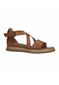 Brown leather sandal with a woven toe strap, adjustable ankle strap, flat sole, and textured brown outsole. Features cross-strap design.